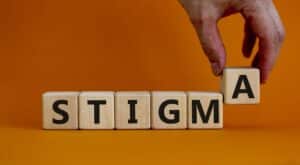 stigma spelled out with wooden letter tiles
