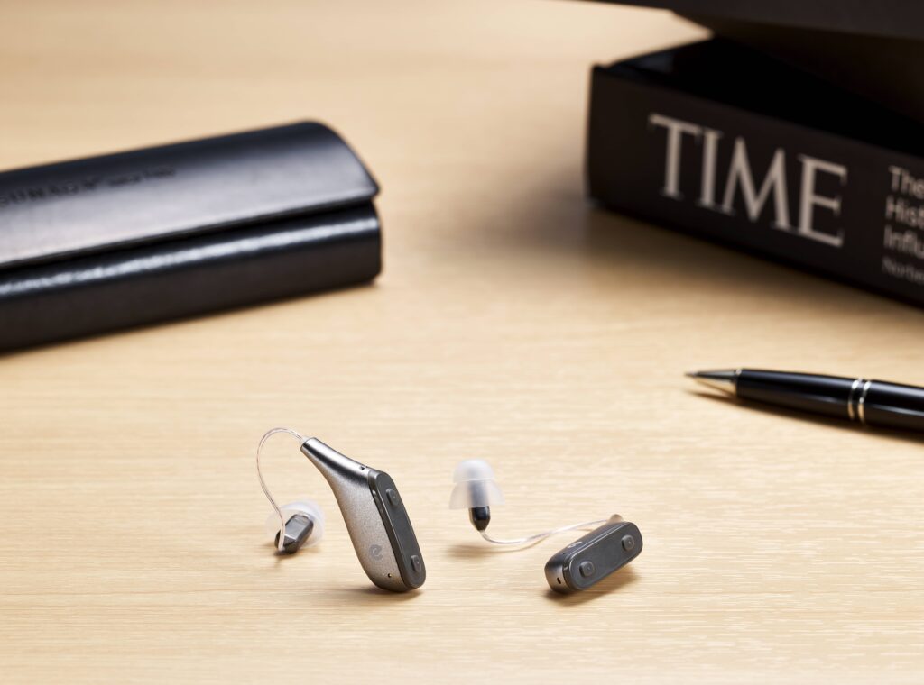 Techmi FacePro OTC hearing aids sitting on table