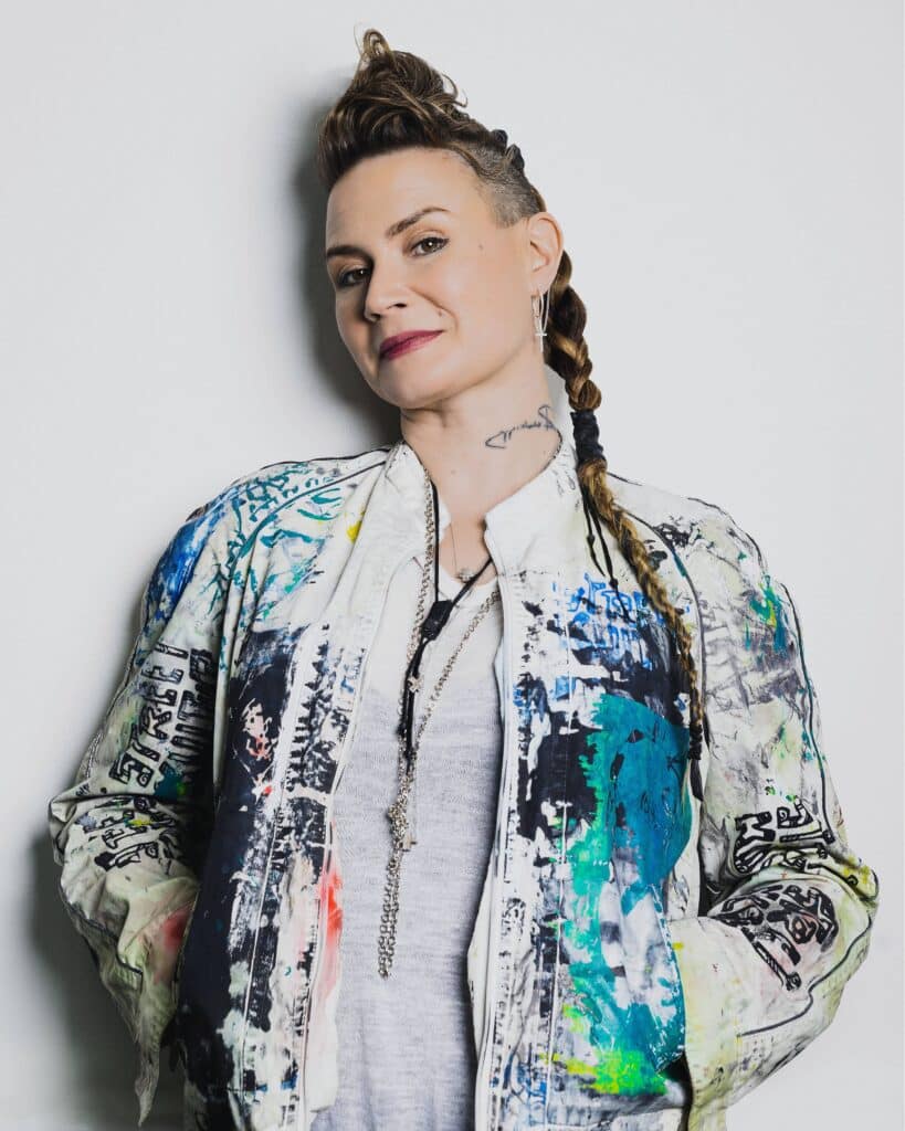 Finnish designer Jenni Ahtiainen, founder of Deafmetal, shown wearing one of her hearing aid jewelry designs.