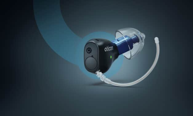 The new Oticon Zeal hearing aid shown against blue background. It combines an in-the-ear design with AI sound processing, rechargeability, and advanced connectivity options.