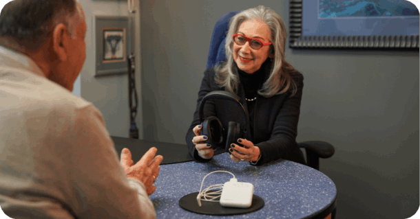 Gail Brenner, AuD, holding the Lenire device at Treble Health Tinnitus Treatment Center of Philadelphia.