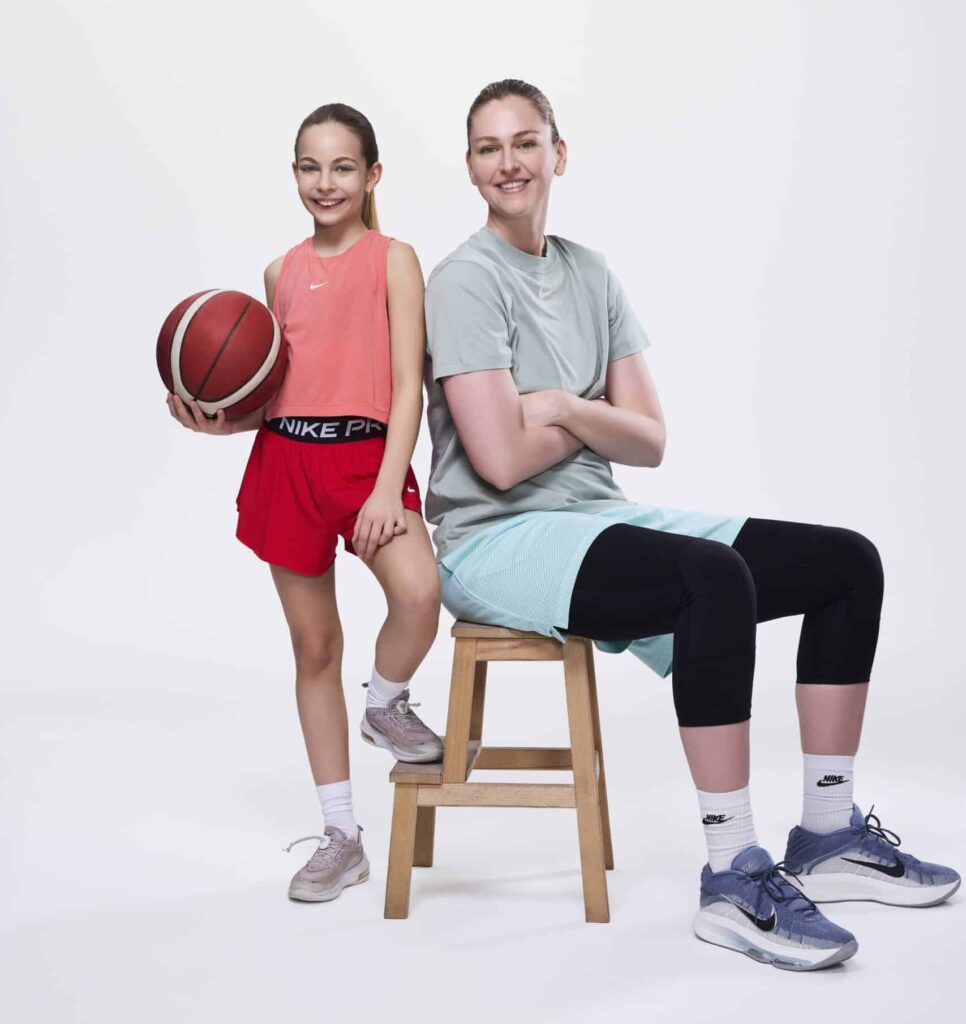 Professional basketball player and EuroLeague champion Emma Meesseman, a Phonak ambassador, posing with a girl holding a basketball