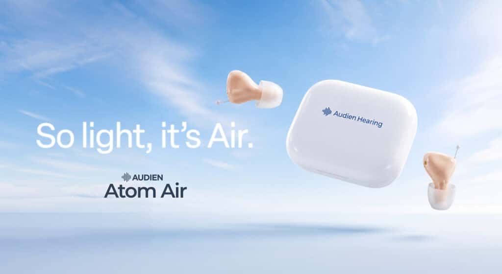 Audien Atom Air OTC hearing aids shown floating in the sky next to a white charging case with the words So light, it's Air