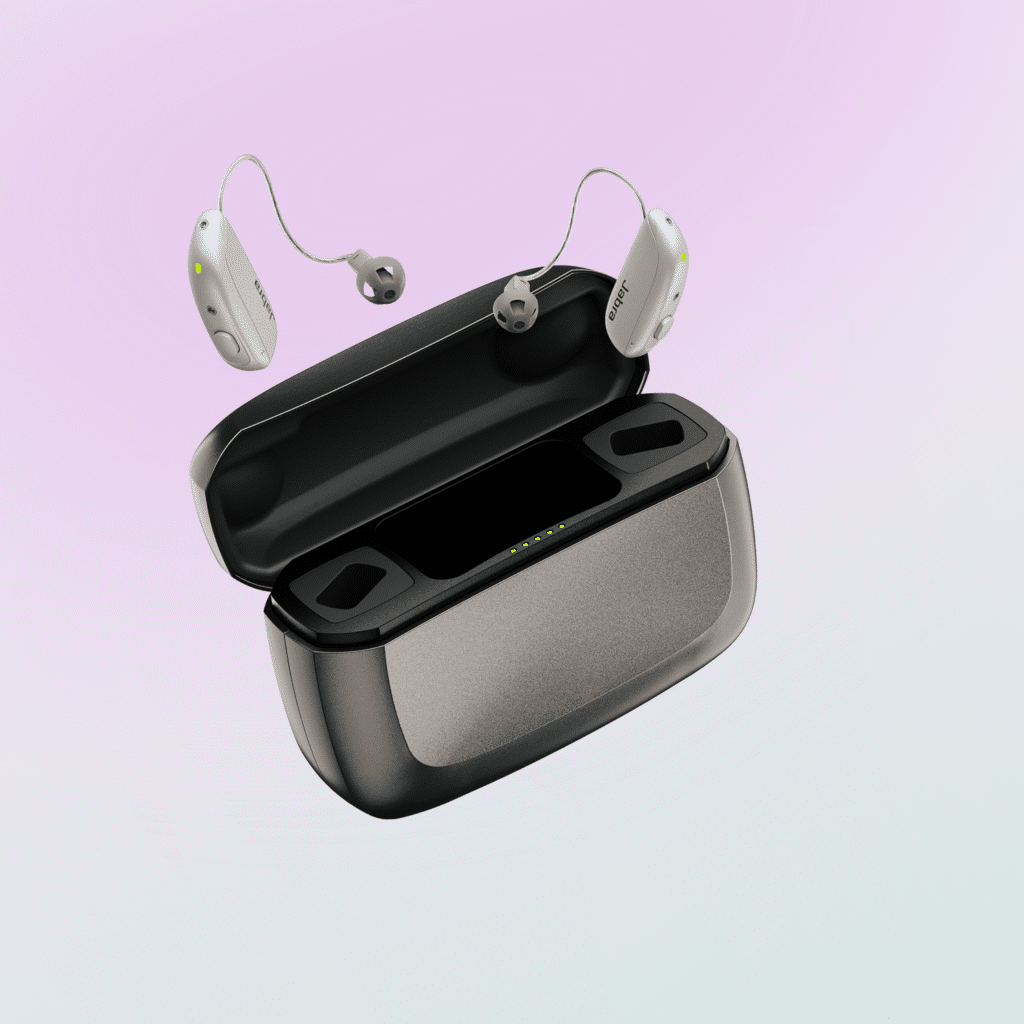 Jabra Enhance M3 OTC hearing aids shown floating above charger against ombre lavender and white background